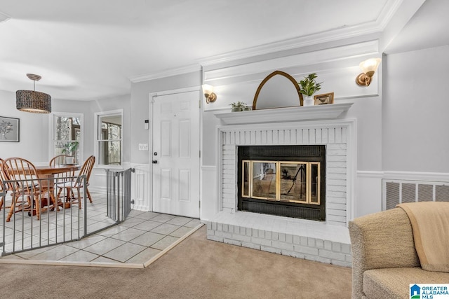 carpeted living room with crown molding and a fireplace