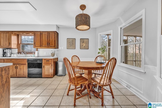 tiled dining room featuring sink