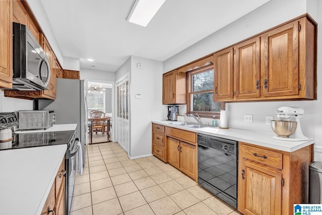 kitchen with appliances with stainless steel finishes, ceiling fan, a wealth of natural light, and sink