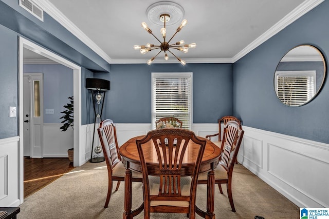 carpeted dining area with a notable chandelier and crown molding