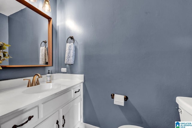 bathroom featuring vanity and toilet