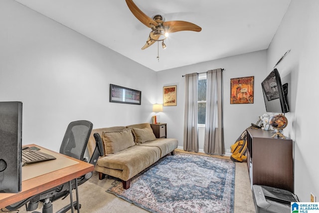 carpeted office space featuring ceiling fan