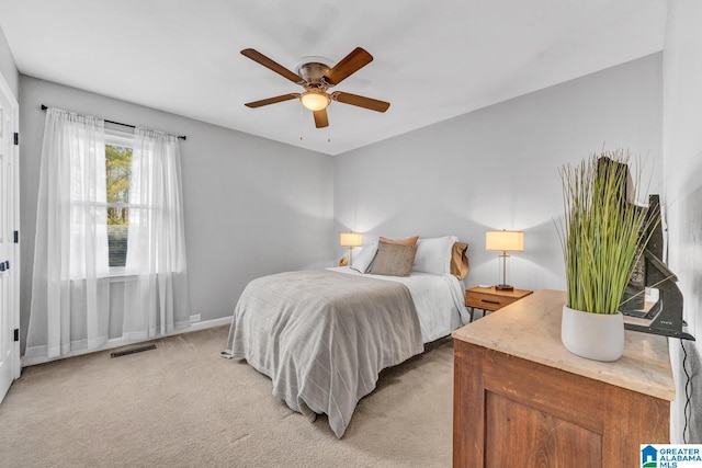 bedroom featuring ceiling fan and light carpet