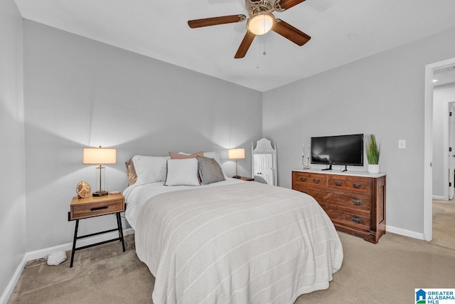 bedroom with ceiling fan and light carpet