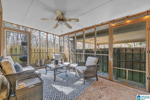 sunroom / solarium featuring ceiling fan