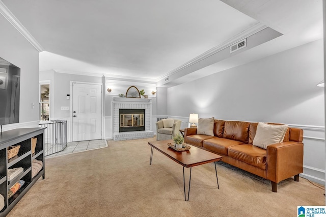 living room featuring light colored carpet, crown molding, and a fireplace