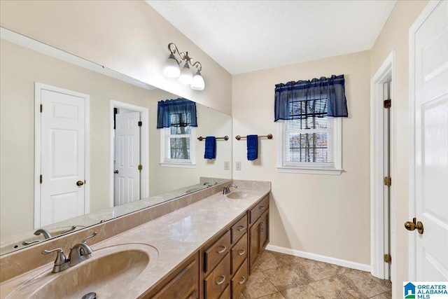 bathroom with a textured ceiling and vanity