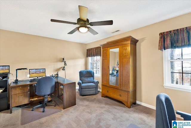 office space featuring ceiling fan and light colored carpet