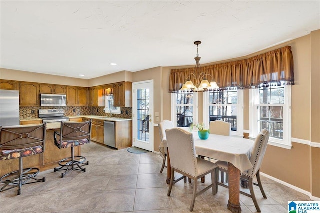 tiled dining area featuring a chandelier