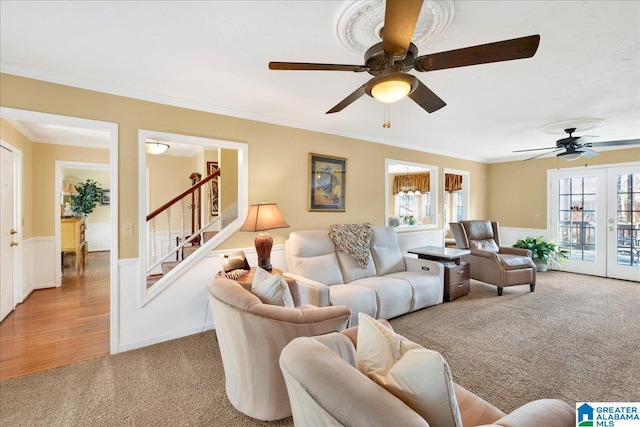 living room with french doors, light carpet, and ornamental molding