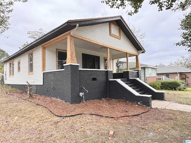 view of property exterior with covered porch