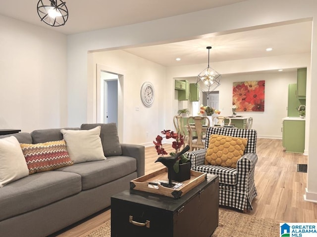 living room featuring light hardwood / wood-style flooring and a chandelier