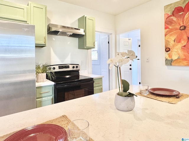 kitchen with stainless steel refrigerator, range with electric cooktop, and green cabinets