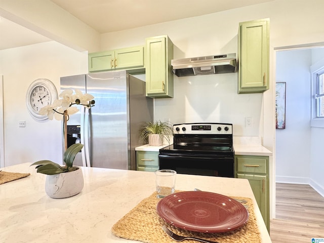 kitchen with stainless steel fridge with ice dispenser, light stone counters, black / electric stove, and green cabinets