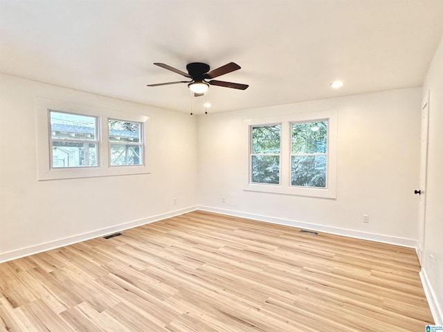 unfurnished room with ceiling fan and light wood-type flooring