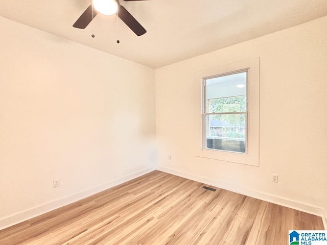 empty room featuring ceiling fan and light hardwood / wood-style flooring