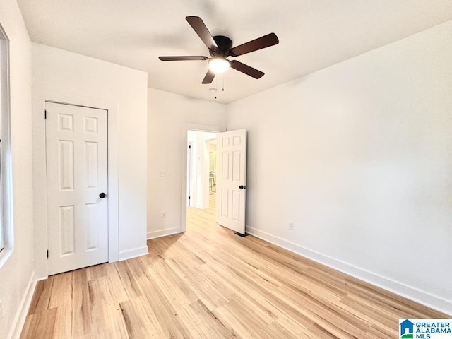 unfurnished bedroom with a closet, ceiling fan, and light hardwood / wood-style floors