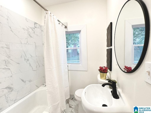 full bathroom featuring toilet, a healthy amount of sunlight, shower / bath combo, and sink