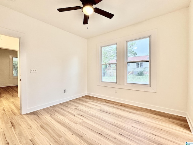 spare room with light wood-type flooring and ceiling fan