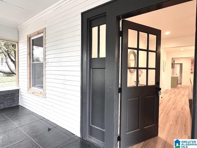 exterior space with ornamental molding and wood walls