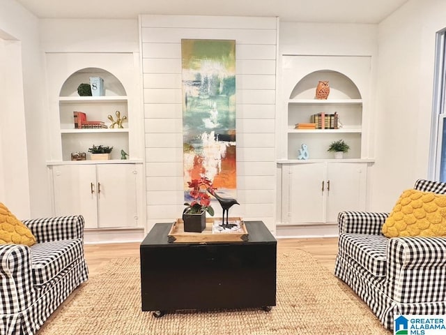 sitting room featuring light hardwood / wood-style floors and built in features