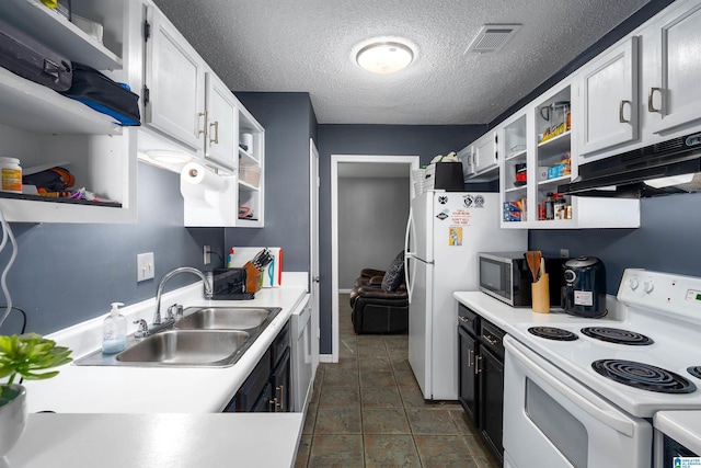 kitchen with sink, white appliances, a textured ceiling, and white cabinets