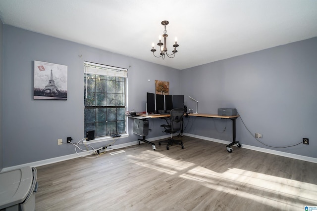 office with hardwood / wood-style floors and an inviting chandelier