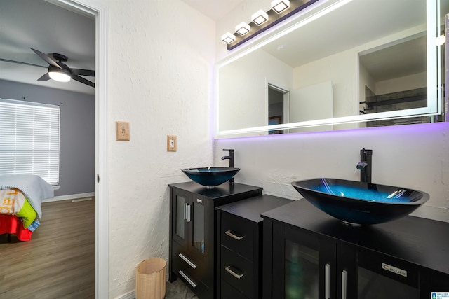 bathroom featuring ceiling fan, hardwood / wood-style floors, and vanity