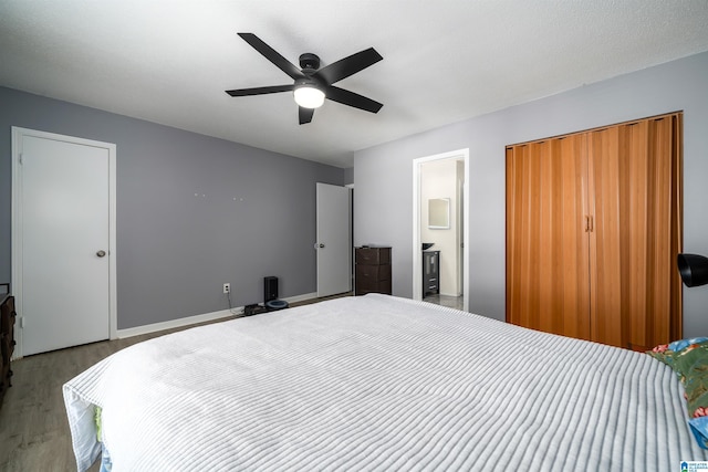 bedroom with light hardwood / wood-style floors, connected bathroom, and ceiling fan