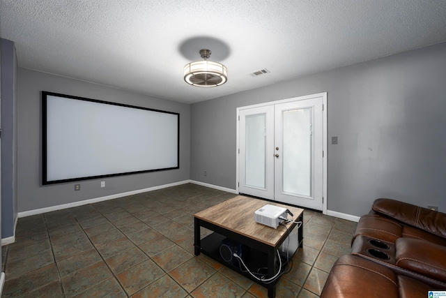 cinema room with a textured ceiling and french doors