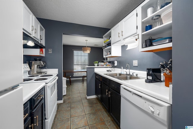 kitchen featuring white cabinetry, sink, pendant lighting, and white appliances