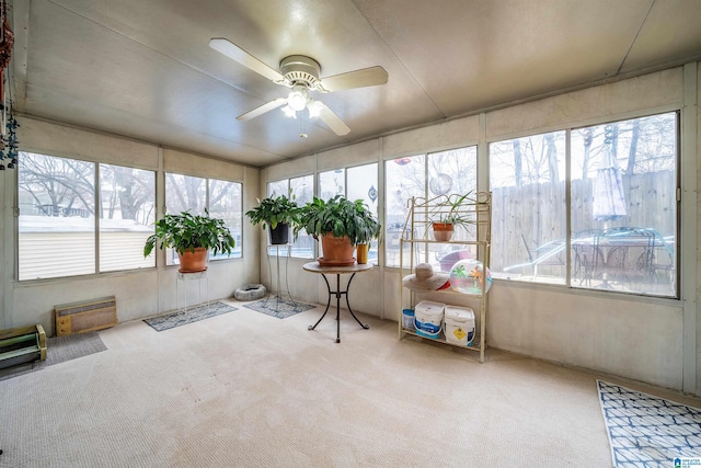 unfurnished sunroom with plenty of natural light and ceiling fan