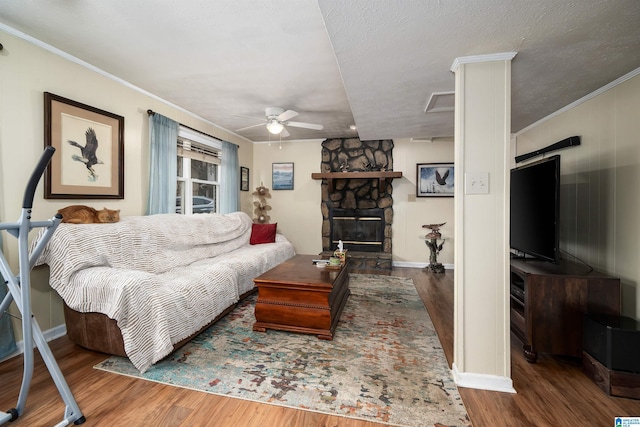 living room with crown molding, hardwood / wood-style flooring, and a textured ceiling