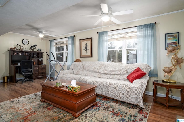 living room featuring hardwood / wood-style flooring, ceiling fan, ornamental molding, and a textured ceiling