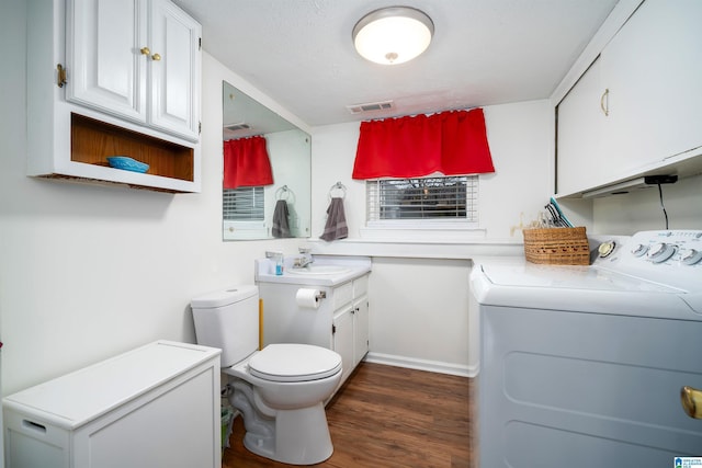 bathroom with vanity, toilet, wood-type flooring, and washer and dryer