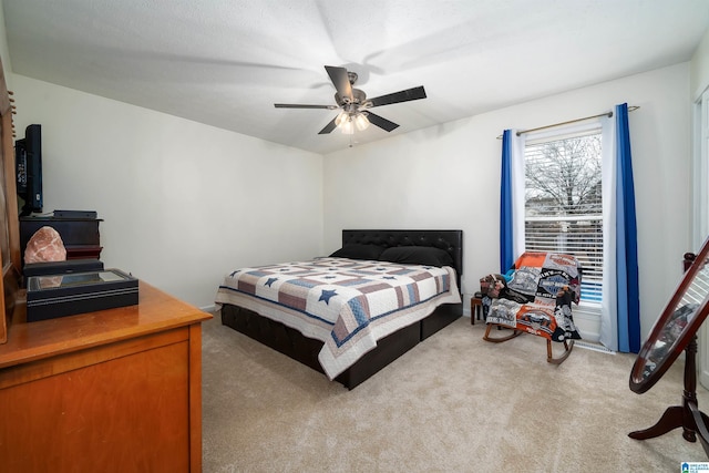 bedroom featuring light colored carpet and ceiling fan