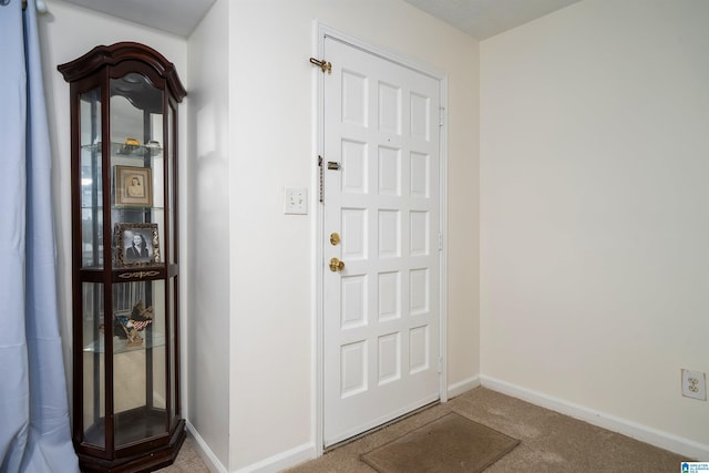 foyer featuring carpet floors