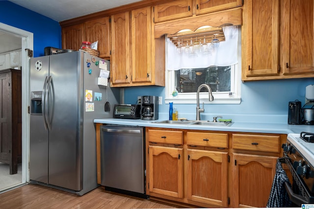 kitchen featuring sink, stainless steel appliances, and light wood-type flooring