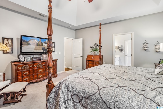 bedroom with light carpet, connected bathroom, and ceiling fan