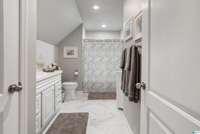 bathroom with lofted ceiling, vanity, toilet, and curtained shower