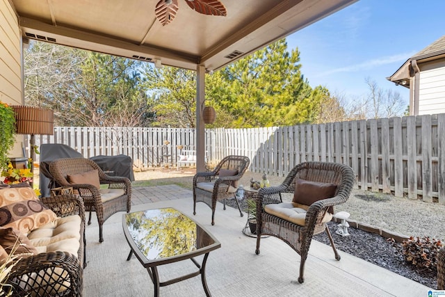 view of patio featuring ceiling fan