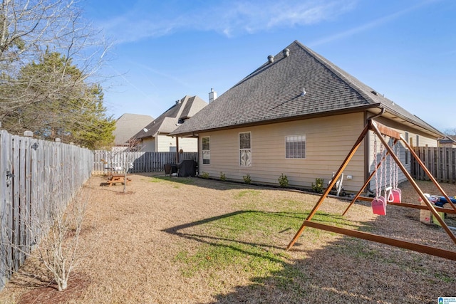 back of house featuring a playground