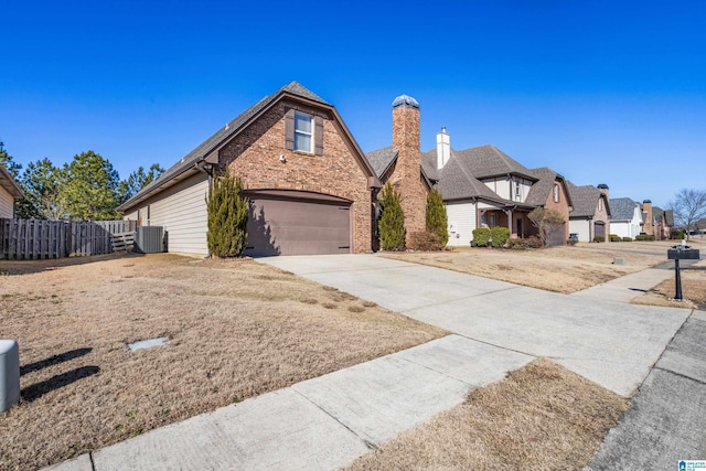 view of front of home featuring a garage and central AC