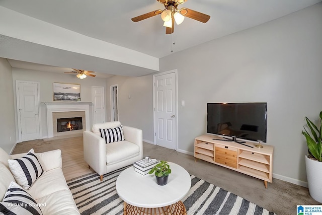 carpeted living room featuring ceiling fan