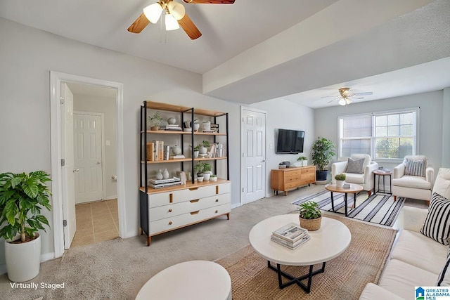 carpeted living room with ceiling fan