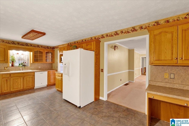 kitchen featuring decorative backsplash, sink, white appliances, and a textured ceiling