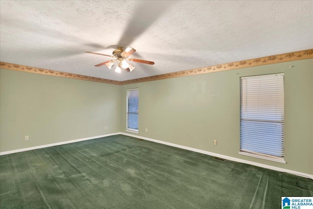 unfurnished room with a textured ceiling, ceiling fan, and dark carpet