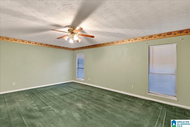 unfurnished room featuring a textured ceiling, ceiling fan, and carpet flooring