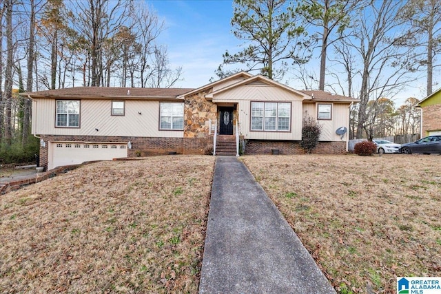 view of front of property with a front yard and a garage