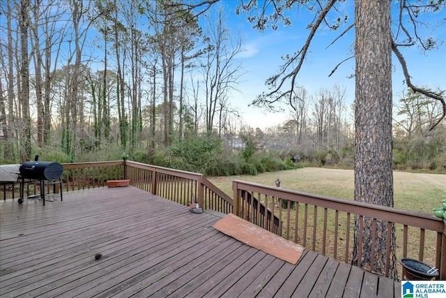 wooden deck with a grill and a yard